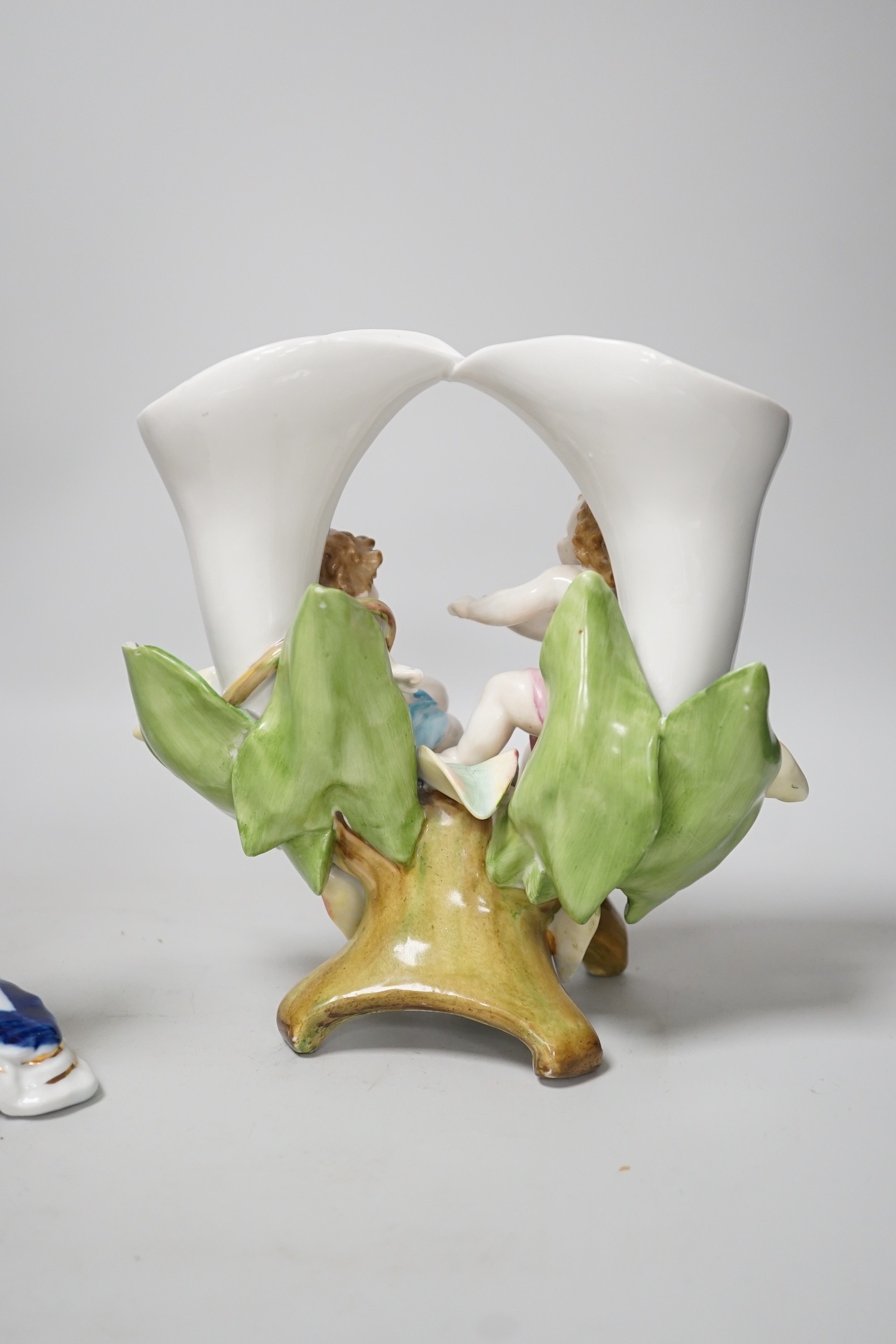 A pair of candlesticks and a figure group flower vase. Tallest 20cm